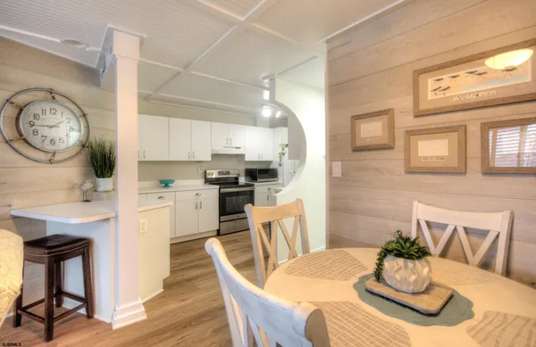a kitchen with cabinets and chairs