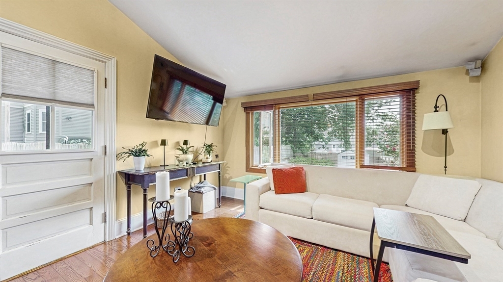 13 Robbins Street, Unit 1 Waltham, MA 02453 - Photo 11 of 29 a living room with furniture and a flat screen tv