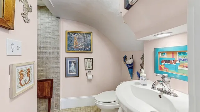 a bathroom with a sink mirror vanity and toilet