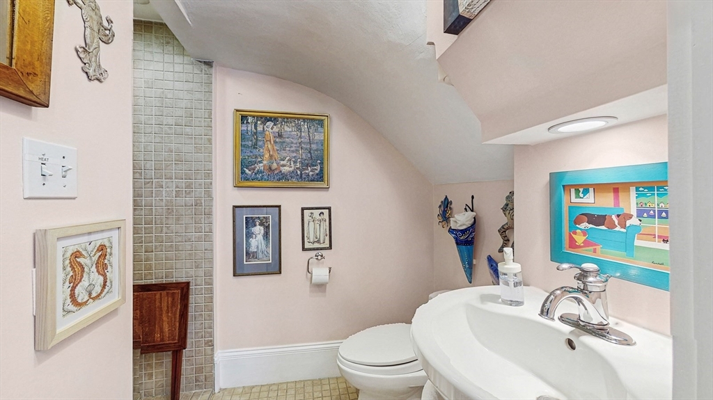 13 Robbins Street, Unit 1 Waltham, MA 02453 - Photo 12 of 29 a bathroom with a sink mirror vanity and toilet