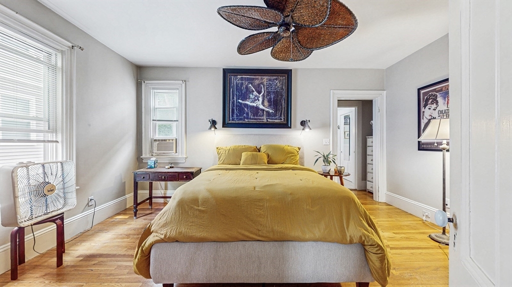 13 Robbins Street, Unit 1 Waltham, MA 02453 - Photo 13 of 29 a bedroom with a bed and wooden floor