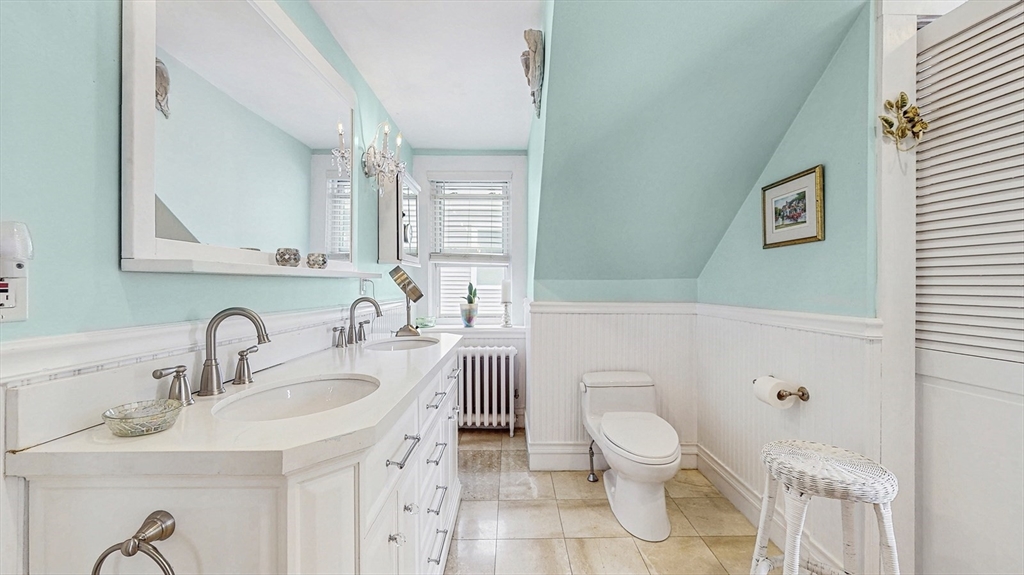 13 Robbins Street, Unit 1 Waltham, MA 02453 - Photo 15 of 29 a bathroom with a toilet sink and mirror