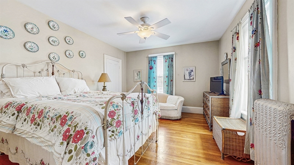 13 Robbins Street, Unit 1 Waltham, MA 02453 - Photo 17 of 29 a bedroom with a bed and a chandelier