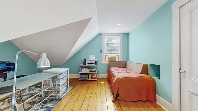 a bedroom with furniture and a wooden floor