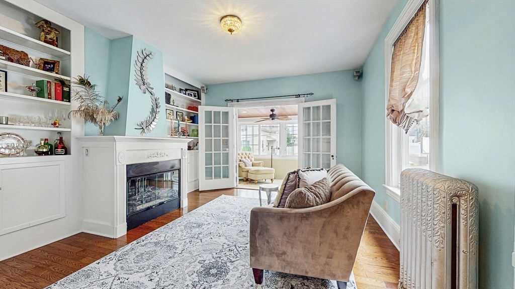 13 Robbins Street, Unit 1 Waltham, MA 02453 - Photo 2 of 29 a living room with furniture and a fireplace