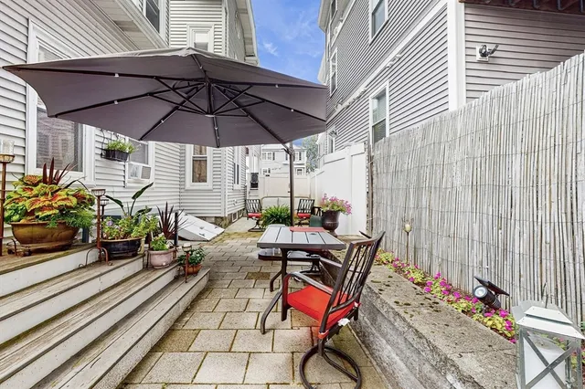 an outdoor sitting area with furniture and wooden floor