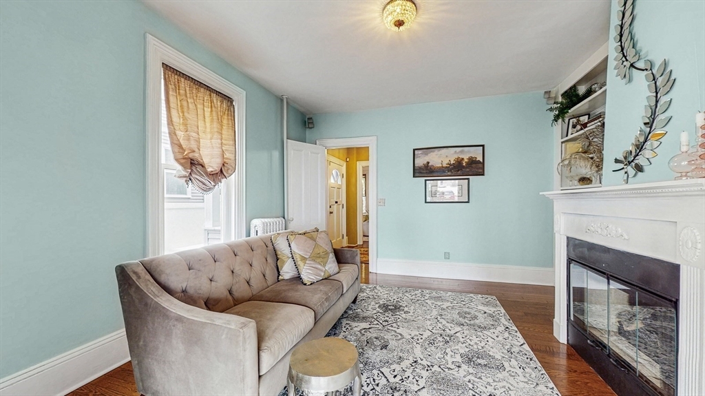 13 Robbins Street, Unit 1 Waltham, MA 02453 - Photo 3 of 29 a living room with furniture and a fireplace