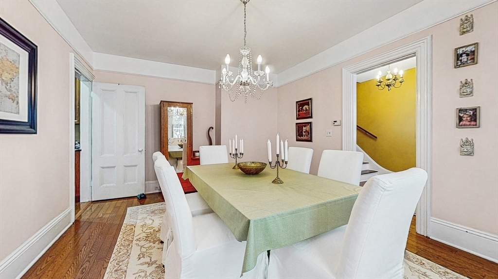 13 Robbins Street, Unit 1 Waltham, MA 02453 - Photo 6 of 29 a view of a dining room with furniture and a chandelier