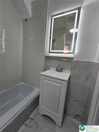 a bathroom with a toilet and a mirror