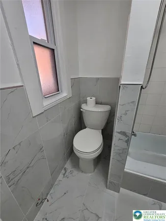 a bathroom with a sink a toilet and a bathtub