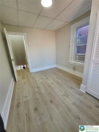 a view of an empty room with wooden floor