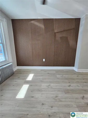 an empty room with wooden floor