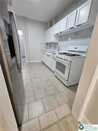 a kitchen with stainless steel appliances a stove a sink and a refrigerator