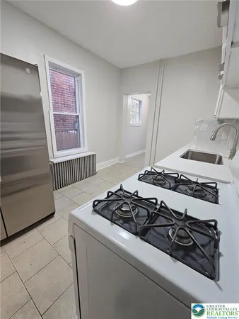 a kitchen with a stove and a window