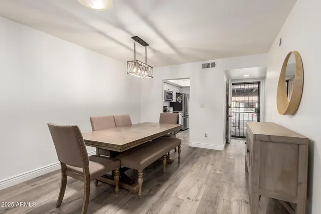 a kitchen with stainless steel appliances granite countertop a kitchen island a stove a sink and a refrigerator