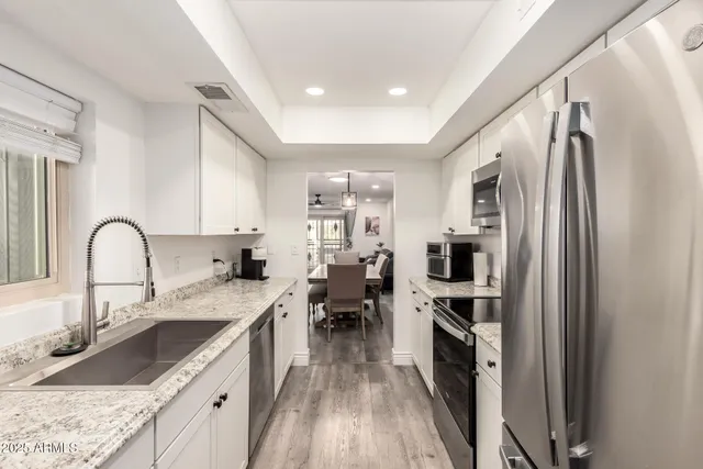 a kitchen with a stove a microwave and wooden cabinets