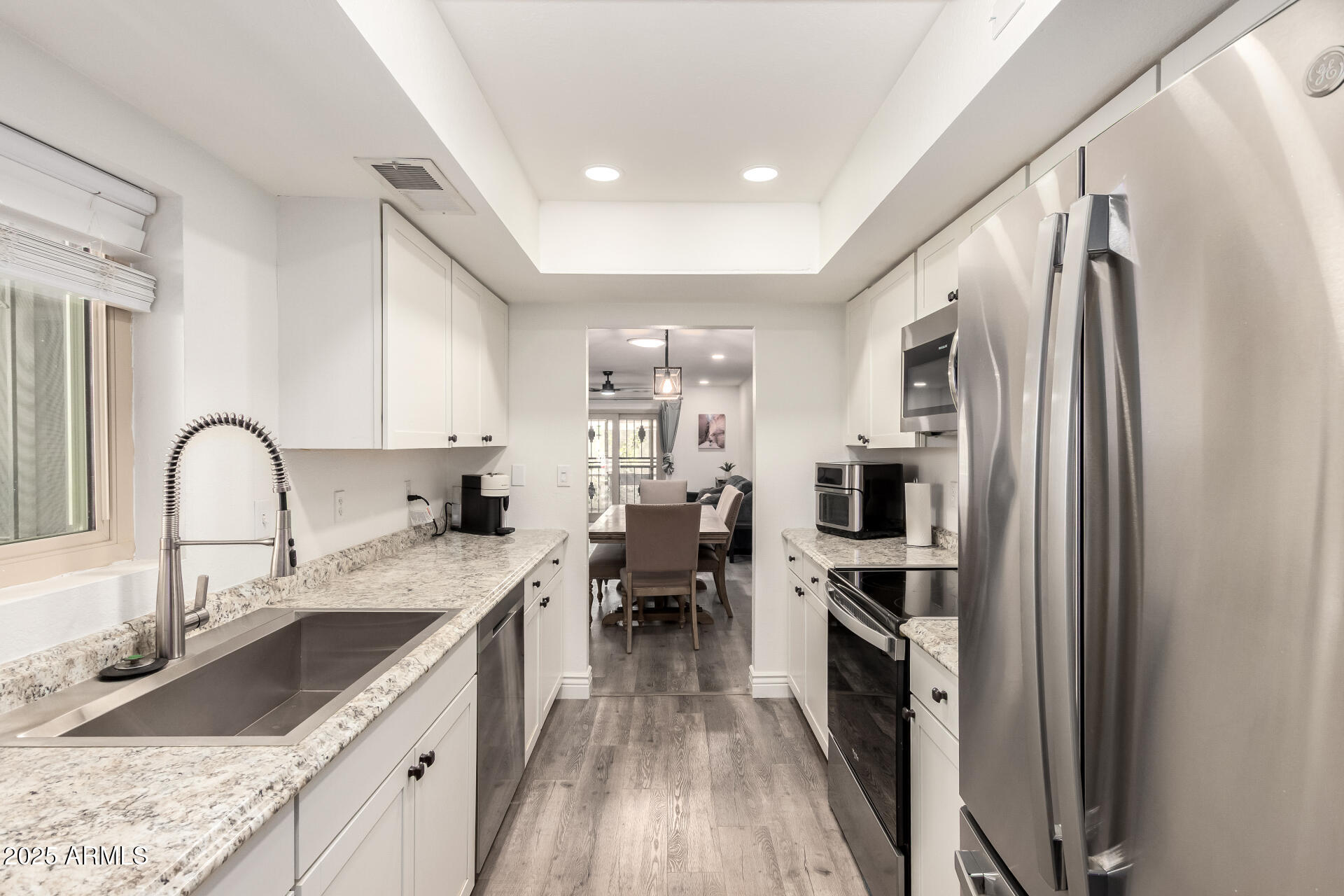 4561 West McLellan Road Glendale, AZ 85301 - Photo 14 of 32 a kitchen with a sink appliances and cabinets