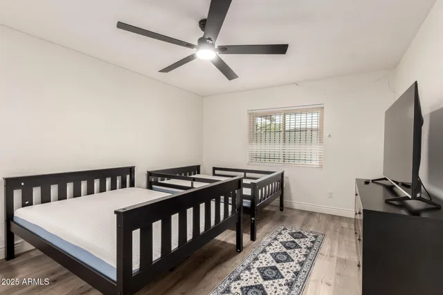 a bedroom with furniture and flat screen tv