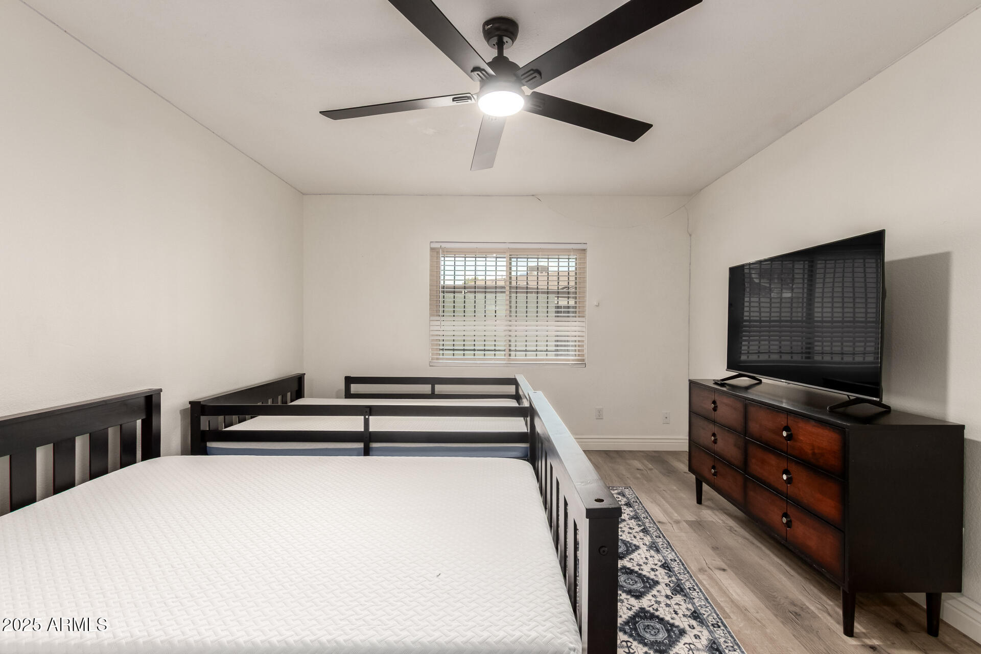 4561 West McLellan Road Glendale, AZ 85301 - Photo 17 of 32 a bedroom with furniture and flat screen tv