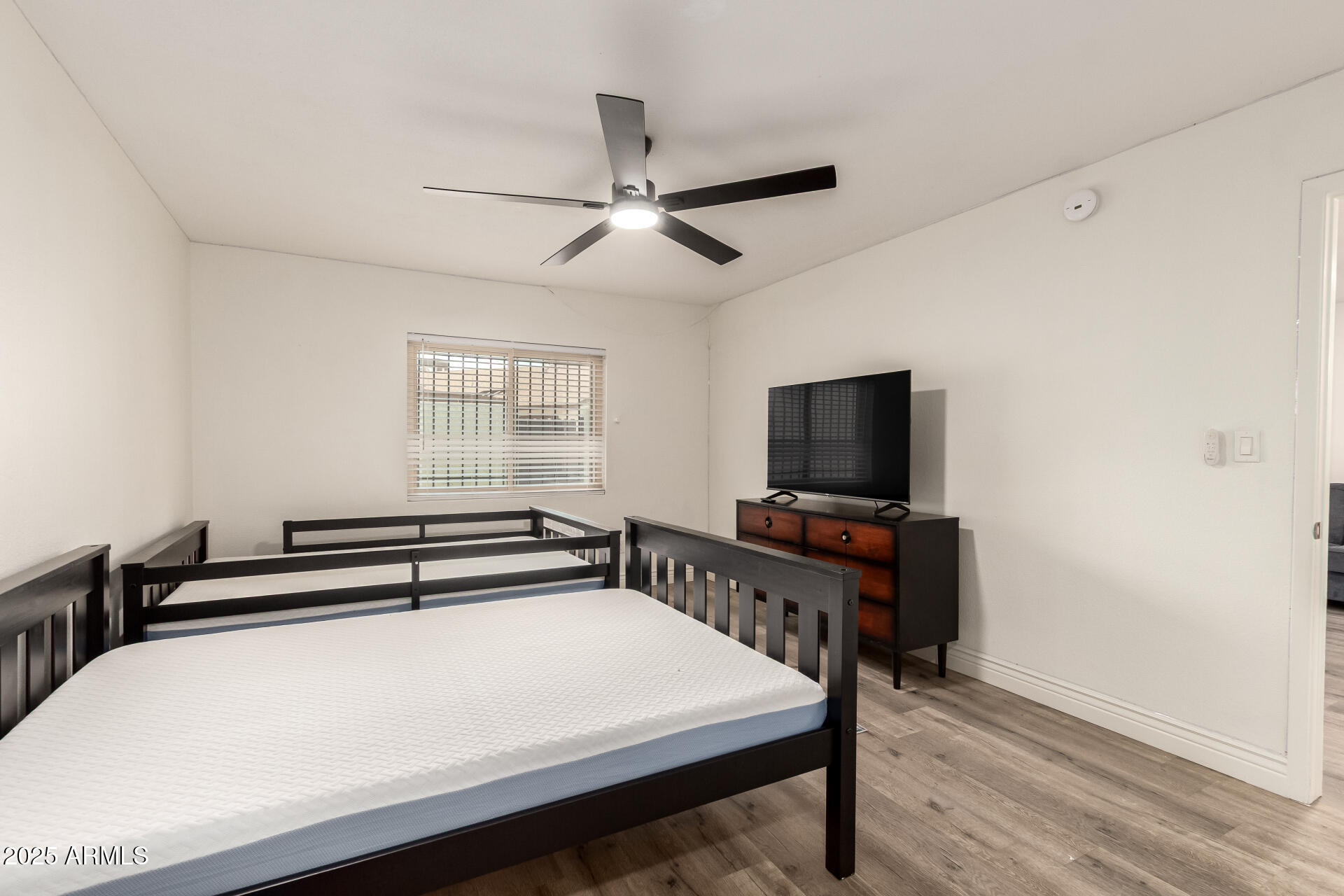 4561 West McLellan Road Glendale, AZ 85301 - Photo 18 of 32 a bedroom with a bed and a flat screen tv