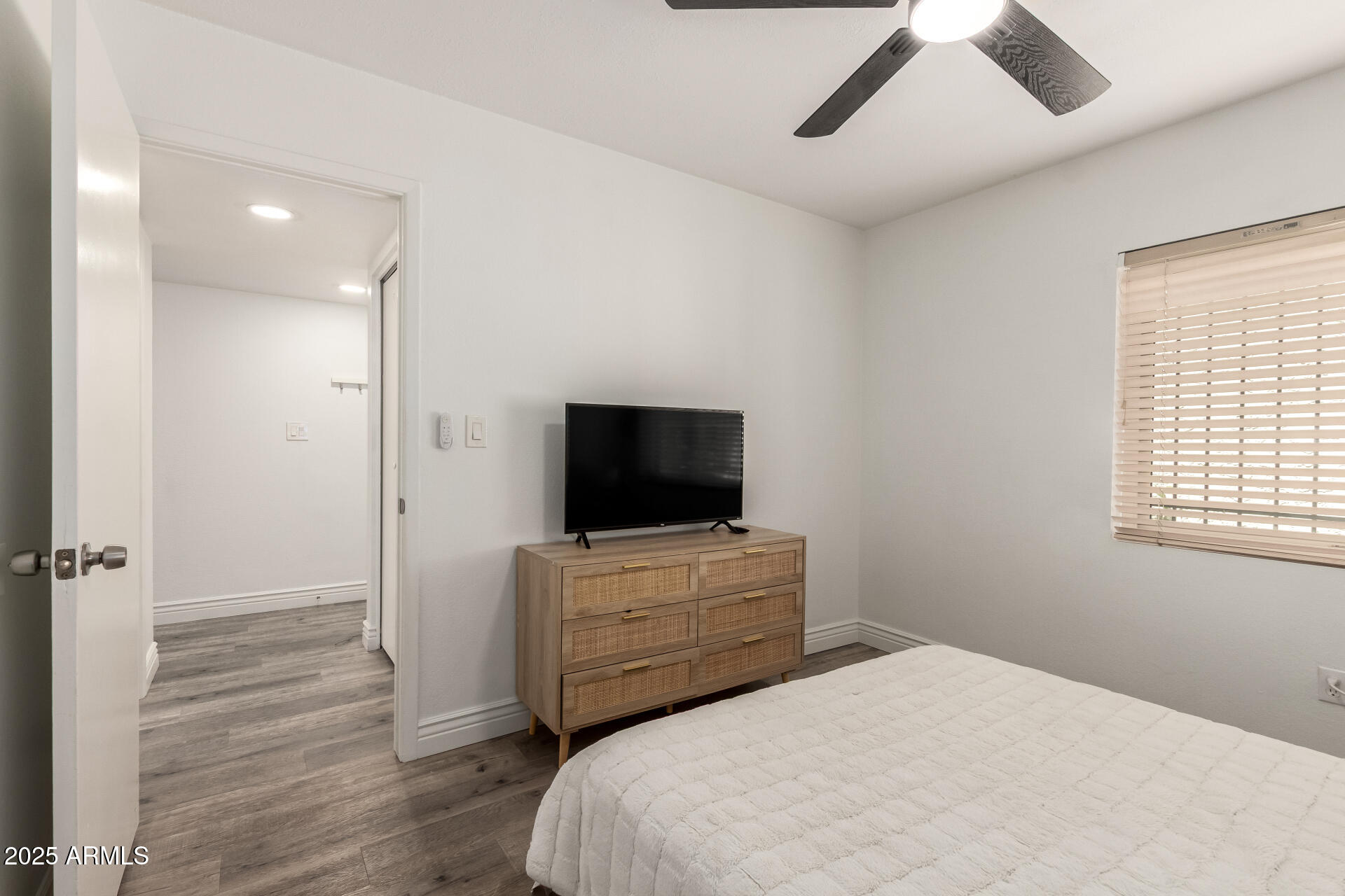 4561 West McLellan Road Glendale, AZ 85301 - Photo 23 of 32 a bedroom with a bed and a flat screen tv
