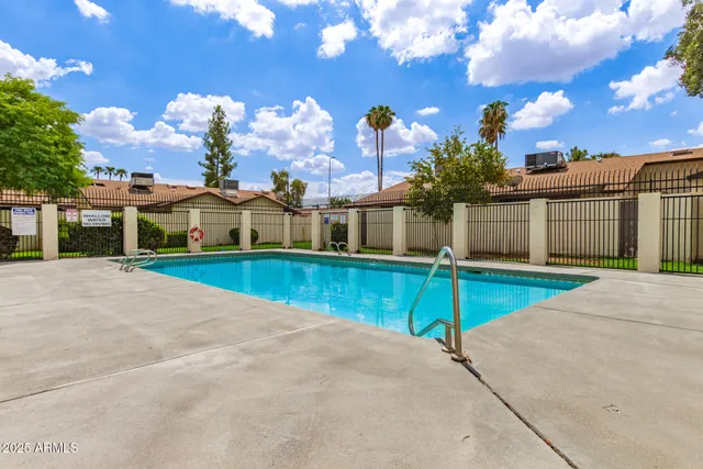 a view of swimming pool with a lounge chairs