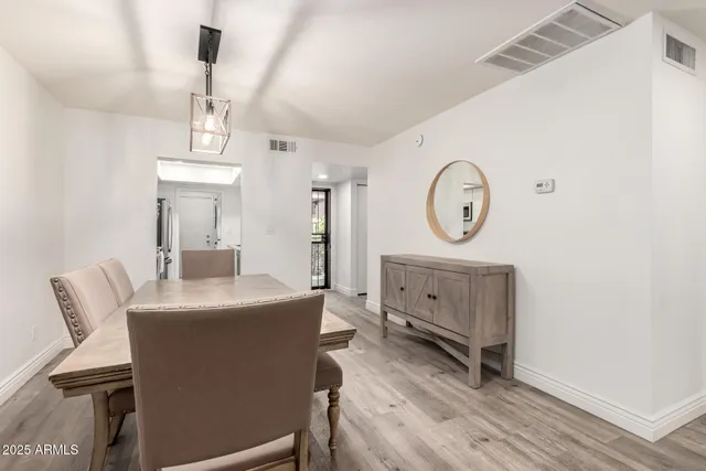 a view of a workspace with furniture and wooden floor