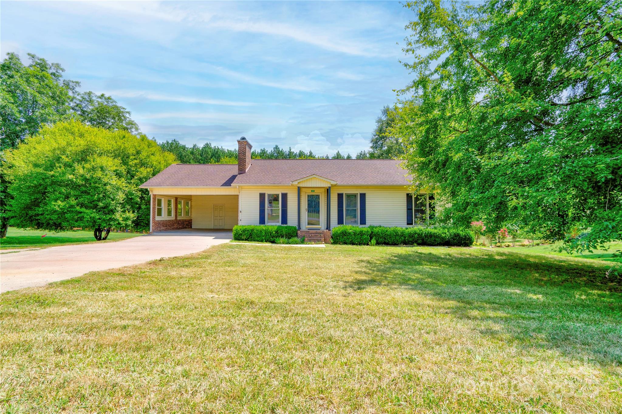 a front view of house with yard and trees