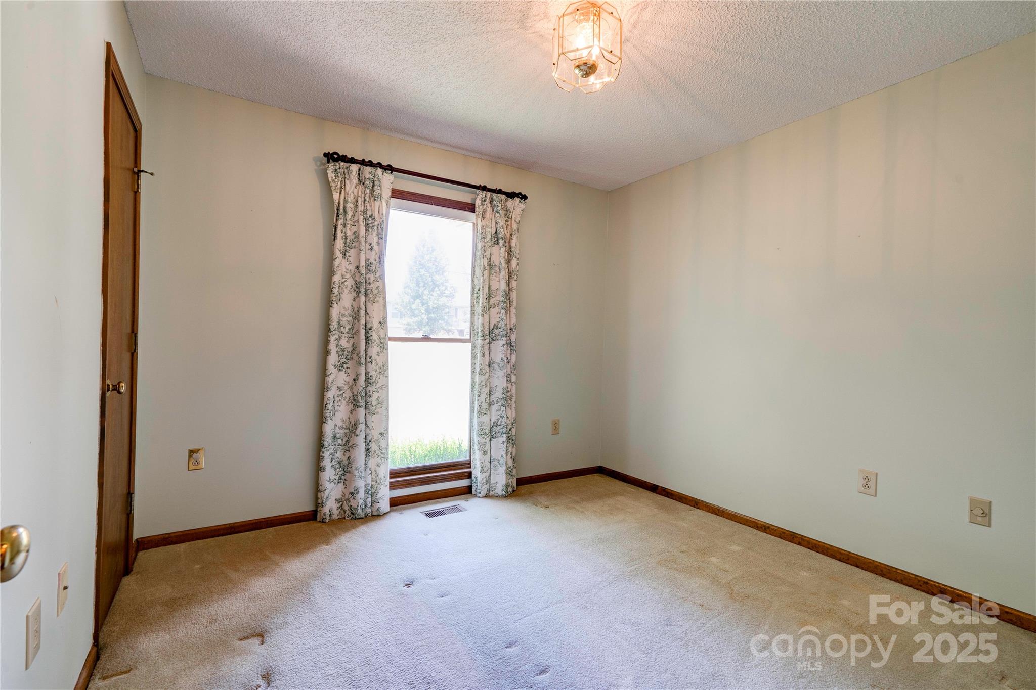145 Ball Park Road Lawndale, NC 28090 - Photo 15 of 37 an empty room with a chandelier fan