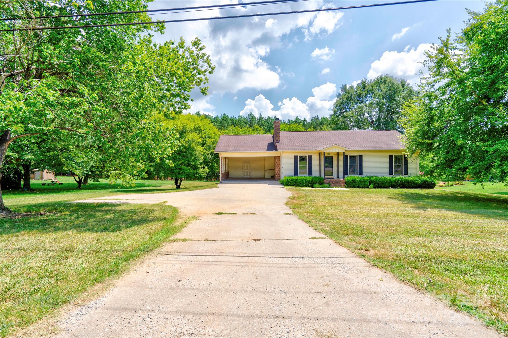 145 Ball Park Road Lawndale, NC 28090 - Photo 2 of 37 a front view of a house with a yard and trees