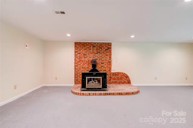 an empty room with a ceiling fan and window