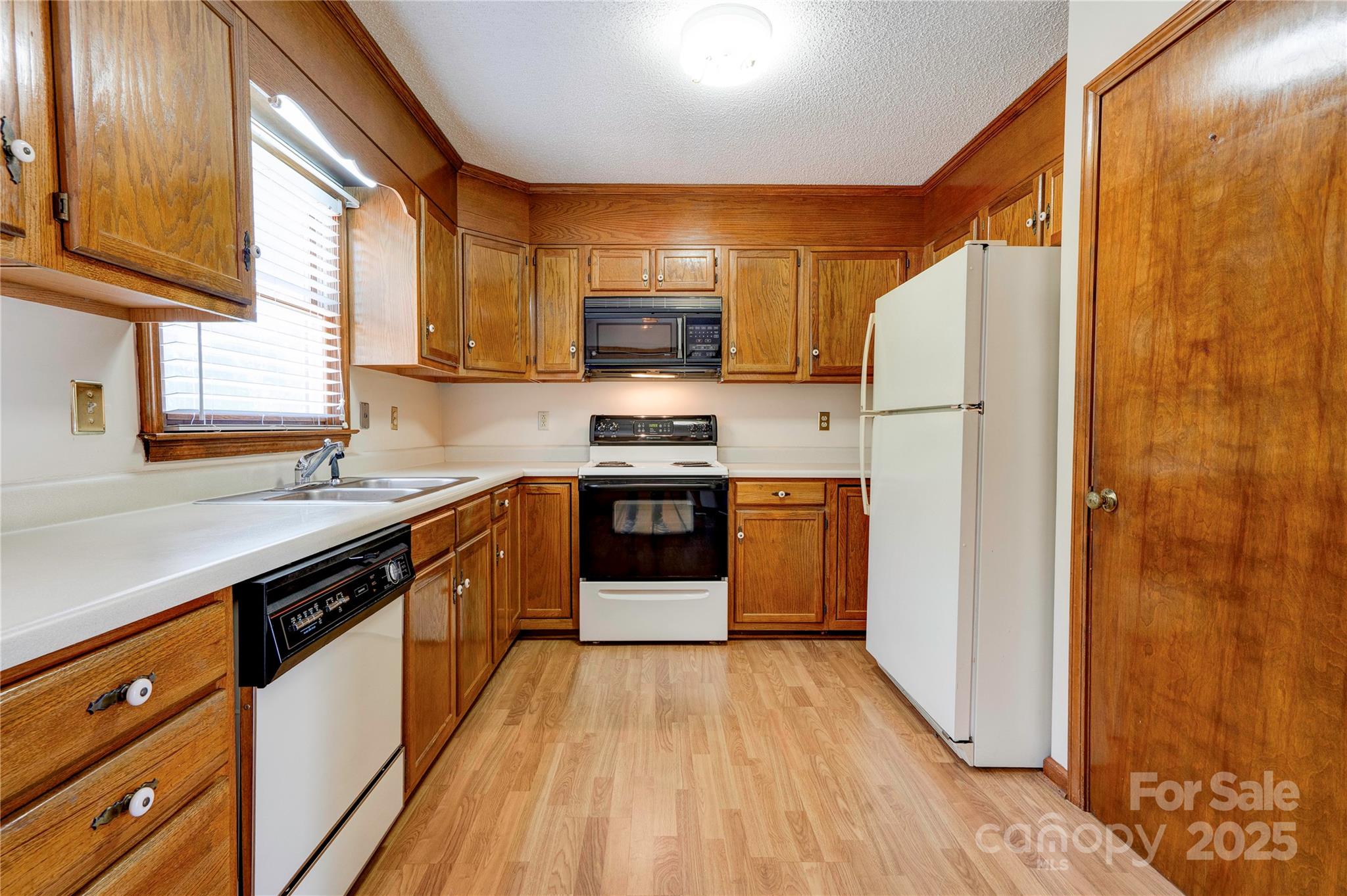145 Ball Park Road Lawndale, NC 28090 - Photo 6 of 37 a kitchen with stainless steel appliances granite countertop a refrigerator a sink dishwasher a stove with wooden floor and cabinets