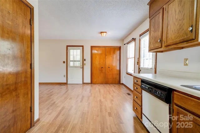 a view of a kitchen with wooden floor and electronic appliances
