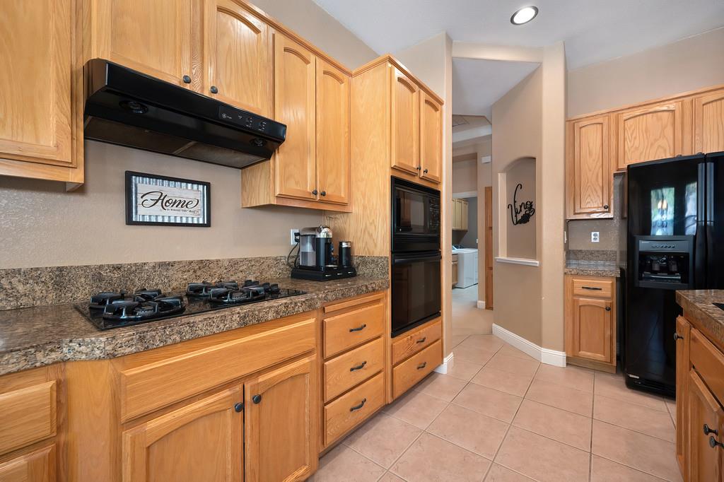 1685 Iroquois Road Rocklin, CA 95765 - Photo 23 of 73 a kitchen with stainless steel appliances granite countertop a refrigerator and a stove top oven