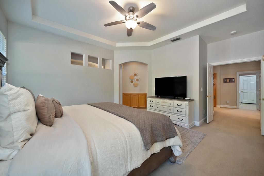 1685 Iroquois Road Rocklin, CA 95765 - Photo 29 of 73 a bedroom with a bed and a flat screen tv