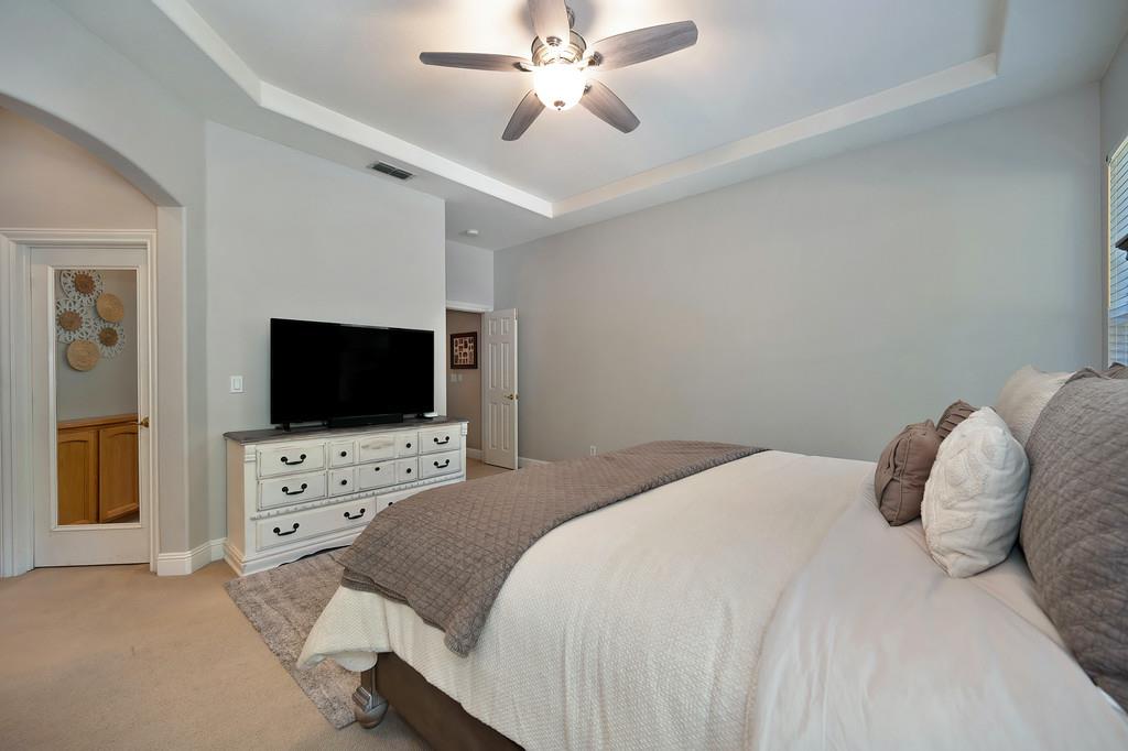 1685 Iroquois Road Rocklin, CA 95765 - Photo 30 of 73 a bedroom with a bed and a flat screen tv