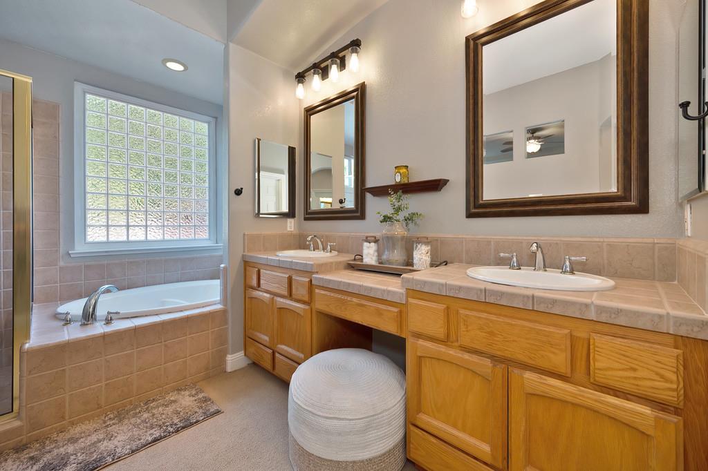 1685 Iroquois Road Rocklin, CA 95765 - Photo 33 of 73 a bathroom with a granite countertop toilet sink and mirror