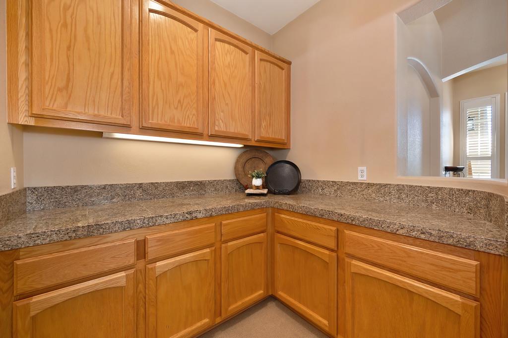 1685 Iroquois Road Rocklin, CA 95765 - Photo 40 of 73 a kitchen with granite countertop white cabinets and a sink