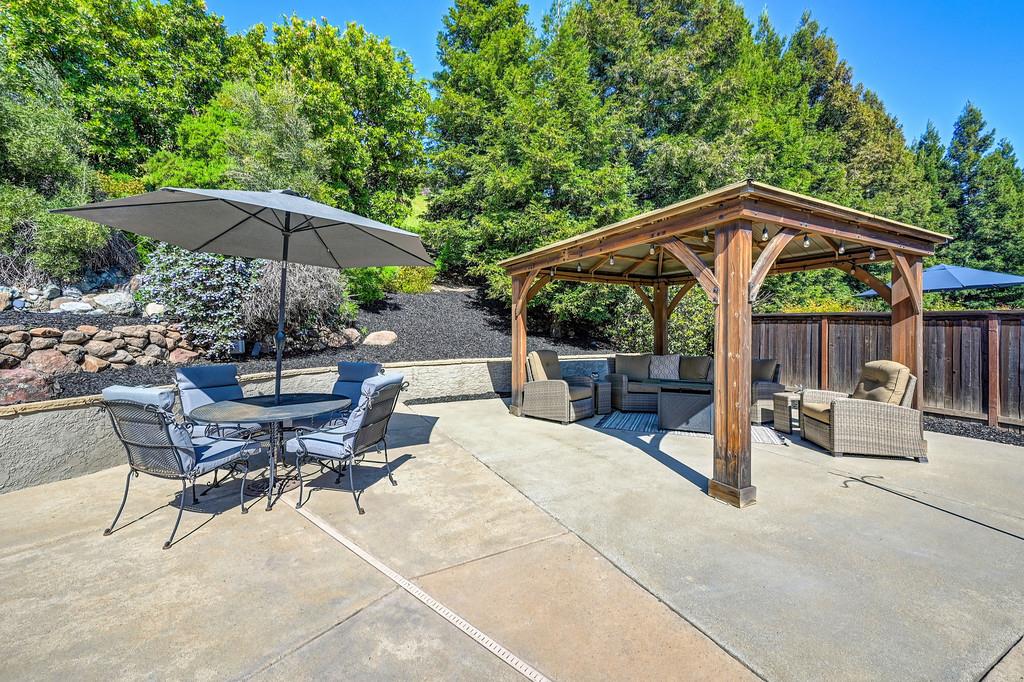 1685 Iroquois Road Rocklin, CA 95765 - Photo 52 of 73 a view of patio with chairs and table under an umbrella