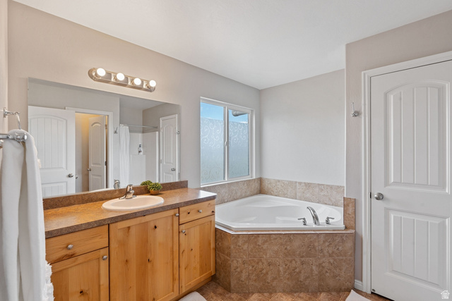 444 South Saddle Road Grantsville, UT 84029 - Photo 13 of 33 Bathroom with vanity, a bath, a shower, and light tile patterned floors