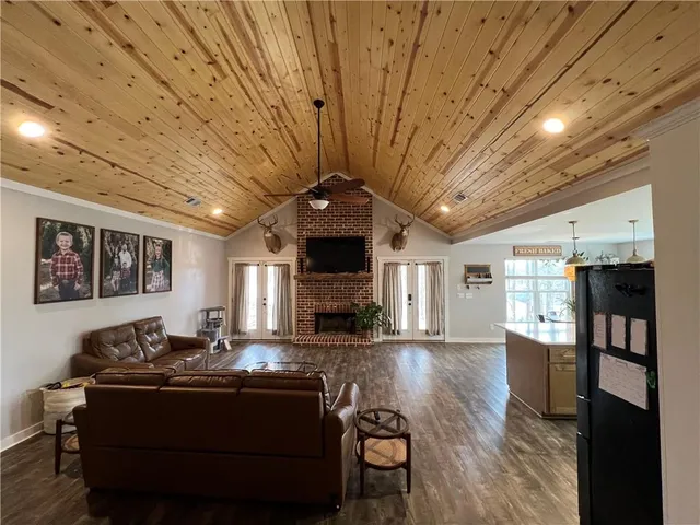 a living room with furniture flat screen tv and a fireplace