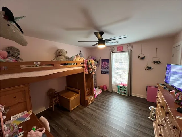 a view of a room with wooden floor and gym equipment