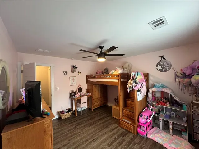 a bedroom with furniture and wooden floor