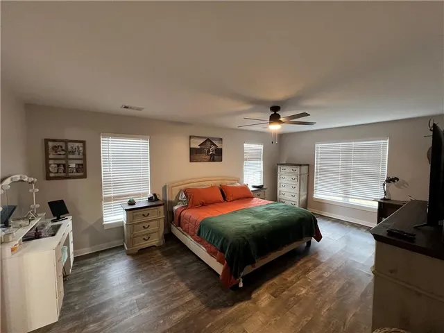 a bedroom with a bed window and a couch