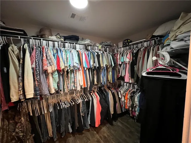 a view of walk in closet with clothes