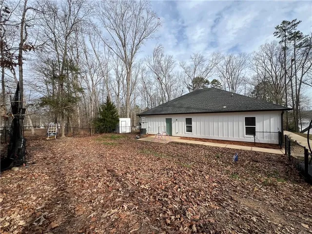 a front view of a house with yard and trees