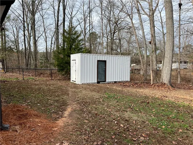 a view of a backyard with large trees