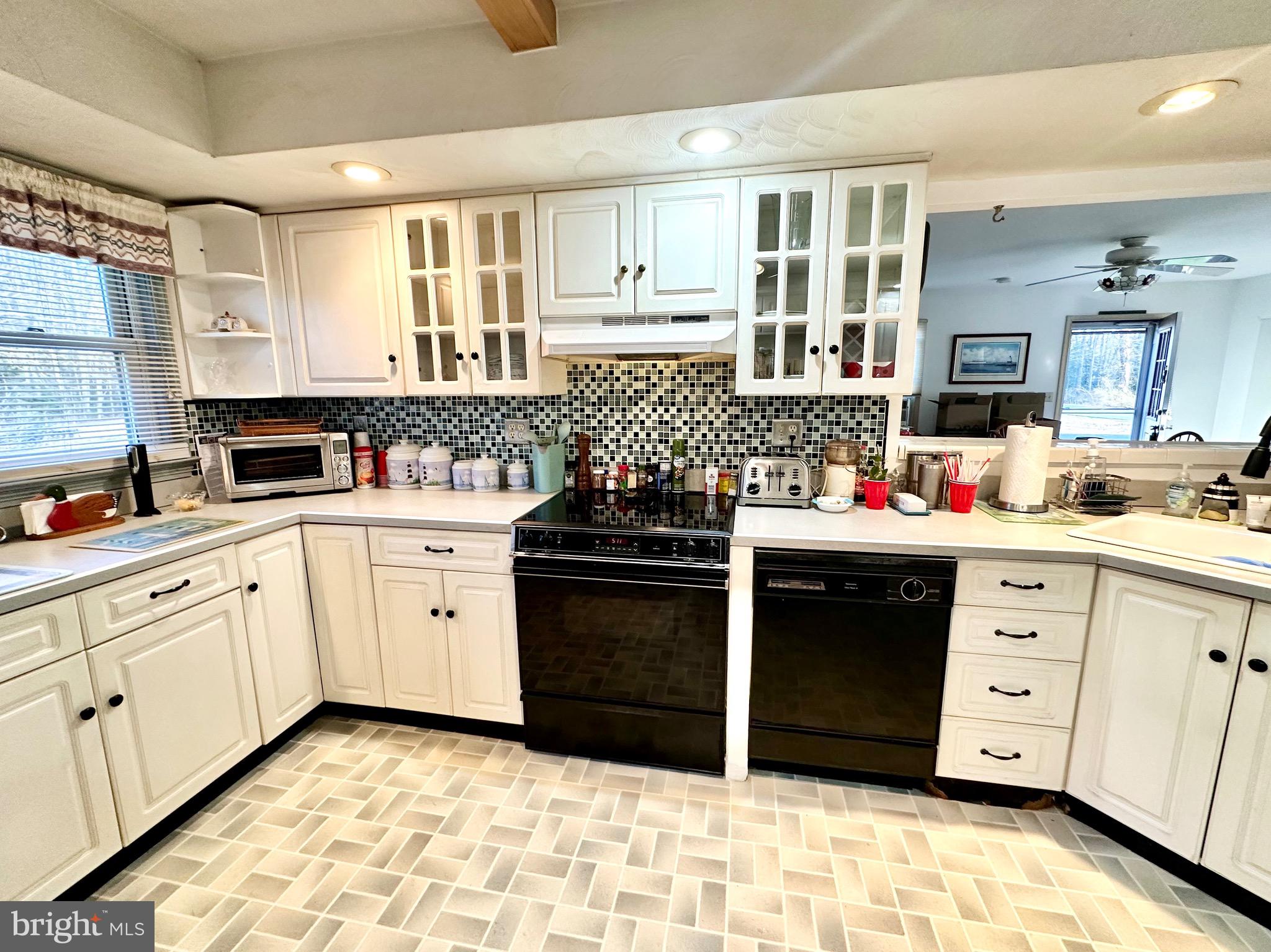 1111 Camp Road Denton, MD 21629 - Photo 24 of 33 a kitchen with white cabinets and appliances