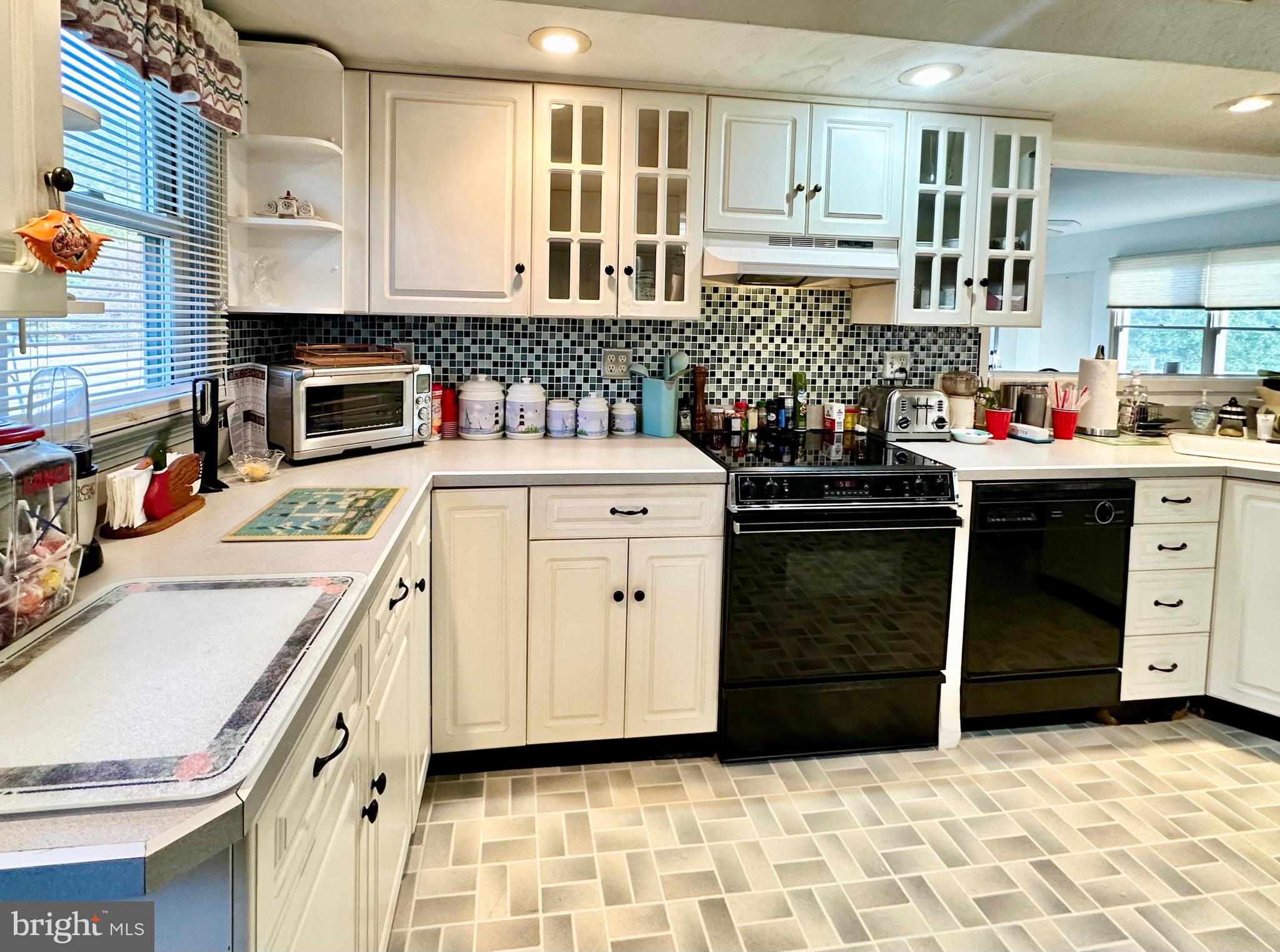 1111 Camp Road Denton, MD 21629 - Photo 27 of 33 a kitchen with a stove sink and cabinets