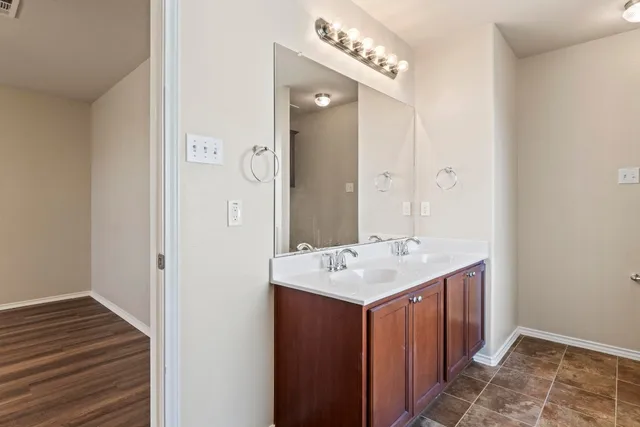 a bathroom with a sink a mirror and vanity